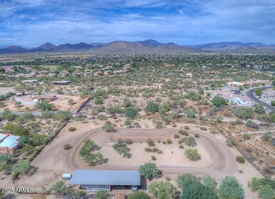 Aerial view of an Arizona horse property with an arena and barn